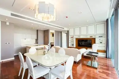 Luxurious open-plan living room with elegant dining area and modern kitchen in a high-end apartment.