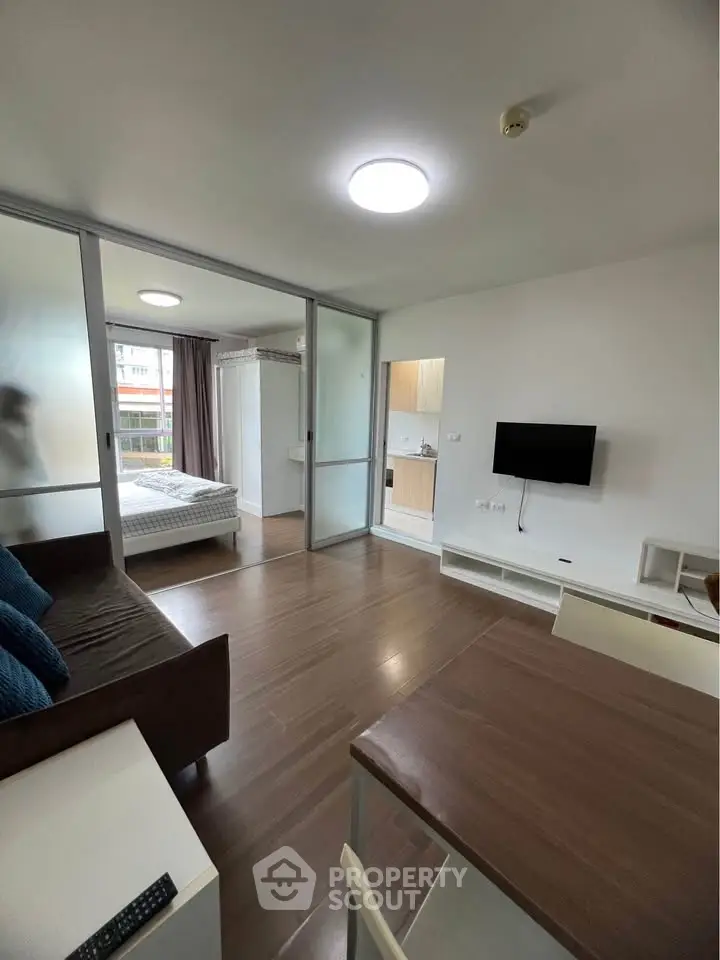 Modern studio apartment with open layout and wooden flooring