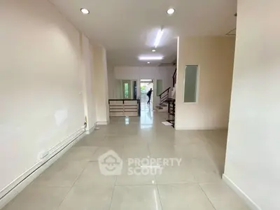 Spacious open-plan interior with tiled flooring and modern staircase, ideal for versatile living arrangements.