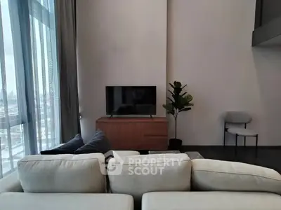 Modern living room with large windows and stylish furniture