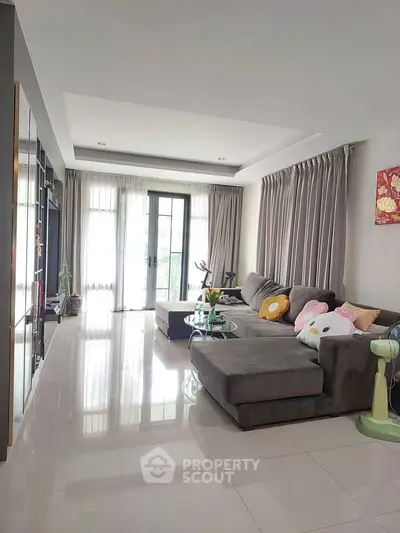 Spacious living room with modern decor and large windows for natural light.