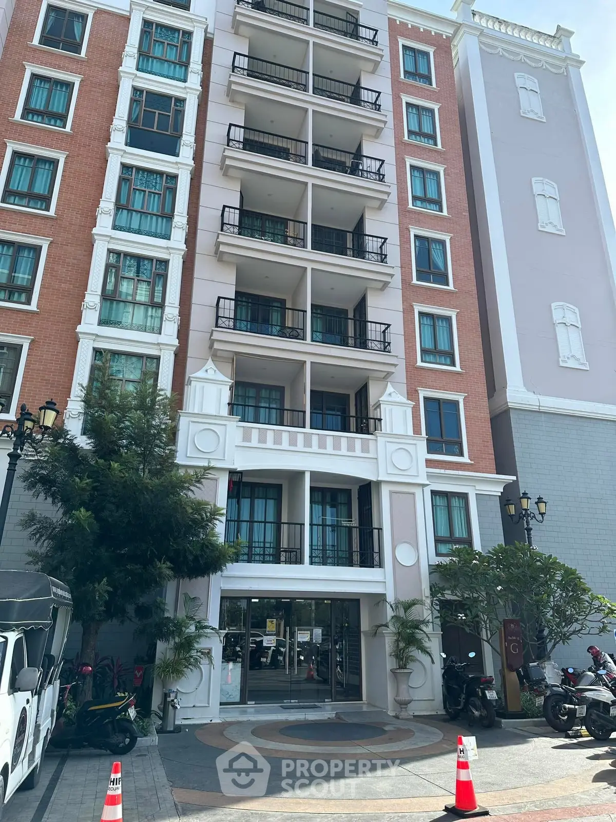 Elegant multi-story residential building with balconies and modern facade