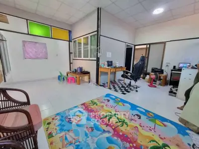 Spacious and colorful living area with vibrant decor and modern furnishings.