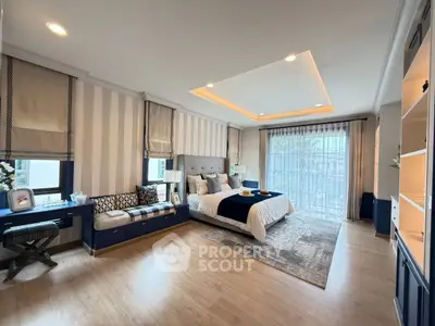 Luxurious bedroom with elegant decor and large windows for natural light.