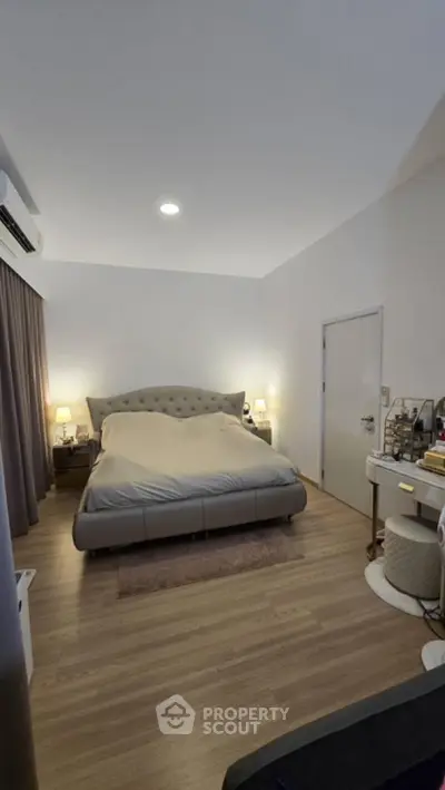 Spacious bedroom with modern decor and cozy lighting