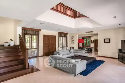 Spacious modern living room with elegant staircase and stylish decor
