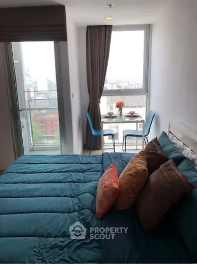 Cozy bedroom with city view and dining area by the window