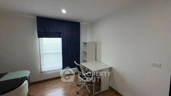 Modern study room with sleek desk and chair, featuring natural light and minimalist design.