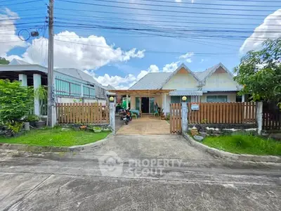 Charming suburban home with a spacious driveway and lush greenery, perfect for family living.