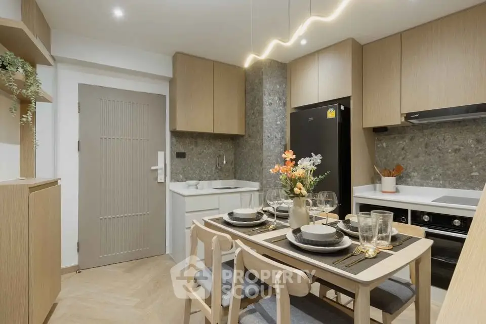 Modern kitchen with elegant dining setup and sleek appliances