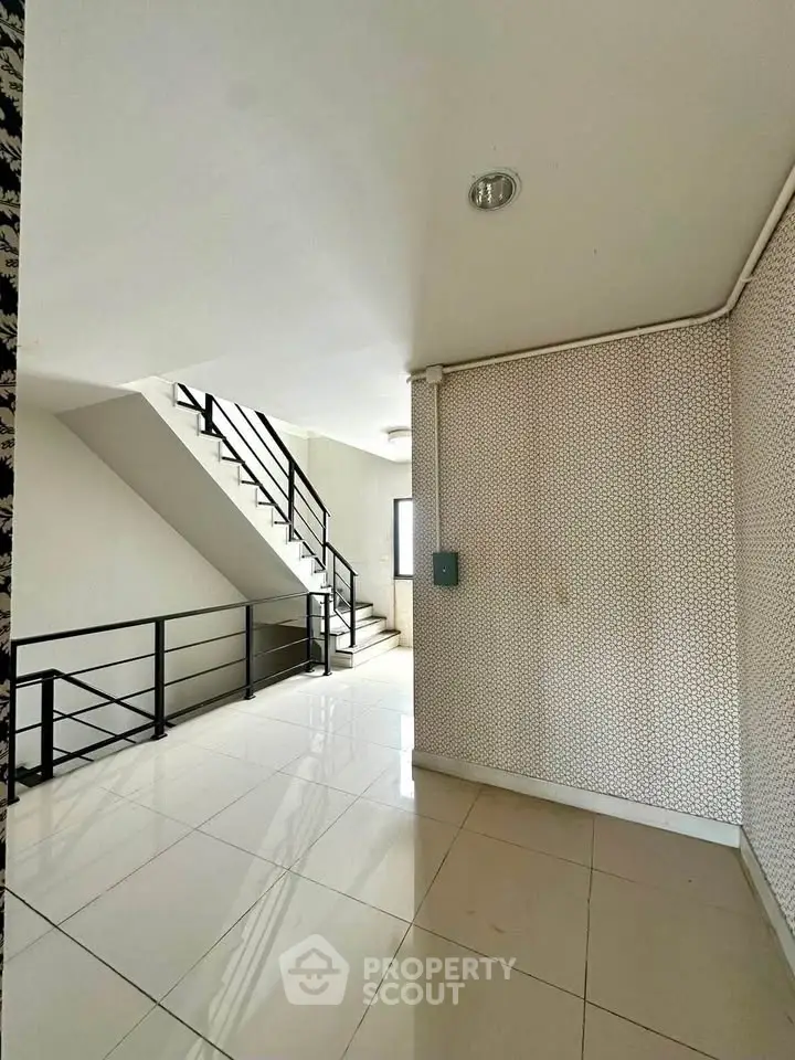 Modern building interior with sleek staircase and glossy tiled floors