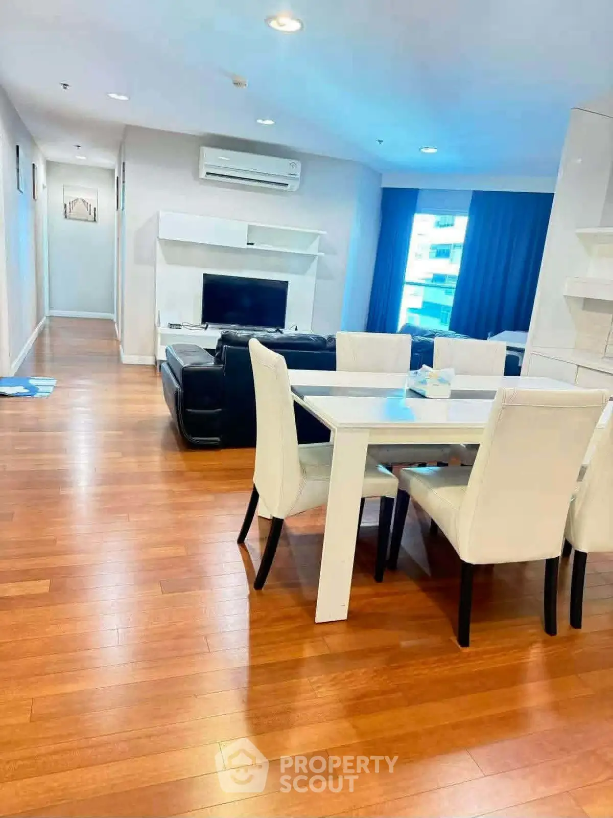 Spacious modern living room with elegant dining area and wooden flooring