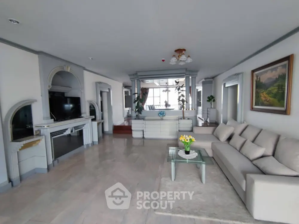 Spacious living room with elegant decor and large windows offering natural light