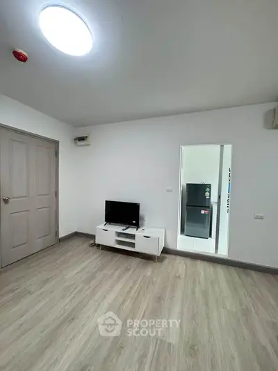 Spacious modern living room with sleek flooring and minimalist decor