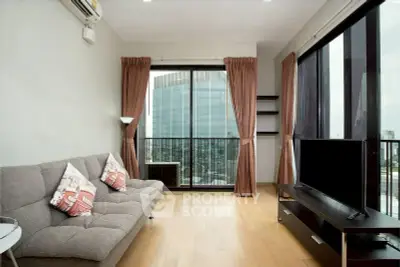 Modern living room with city view, featuring sleek furniture and large windows for natural light.