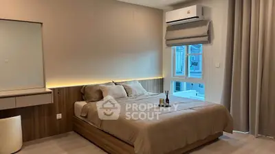 Modern bedroom with stylish decor and natural light