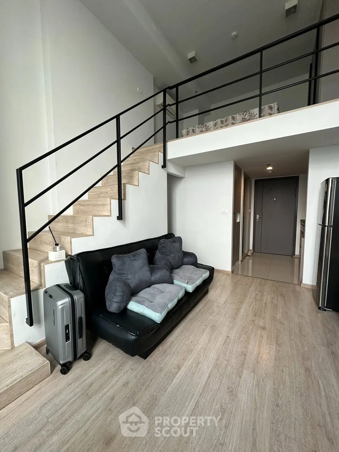 Modern loft apartment with stylish staircase and cozy living area