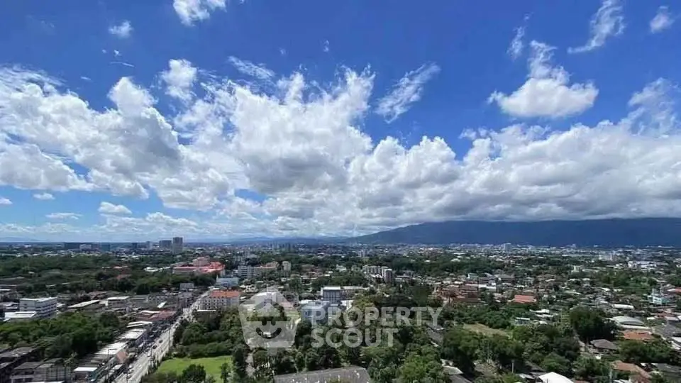 Stunning panoramic cityscape view with lush greenery and clear blue skies, perfect for urban living enthusiasts.