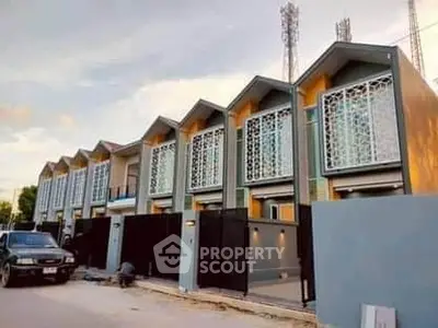 Modern townhouse complex with unique facade design and gated entrance
