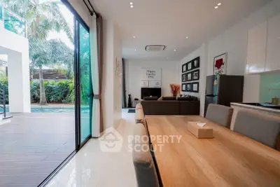 Luxurious open-plan living room with pool view and modern decor