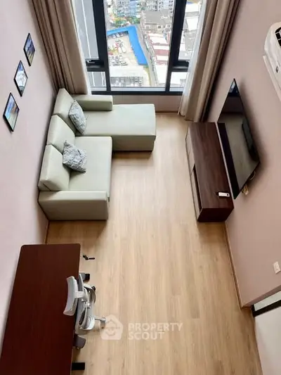 Modern living room with large windows and stylish furniture, offering a bright and inviting atmosphere.