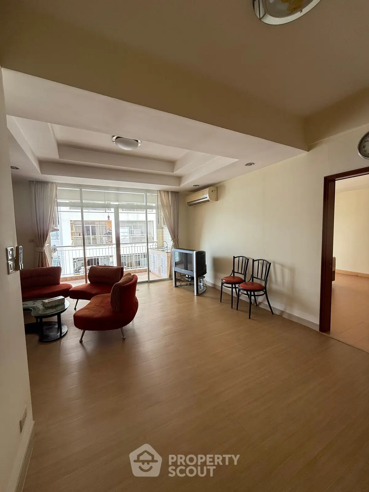 Spacious living room with modern furniture and large windows offering ample natural light.
