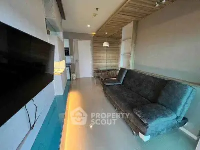 Modern living room with sleek design and cozy seating in a stylish apartment.