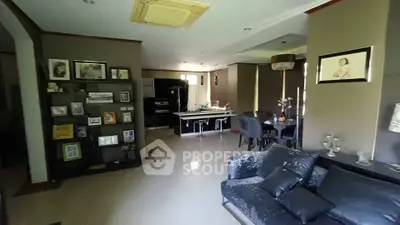 Spacious living room with modern decor and open dining area