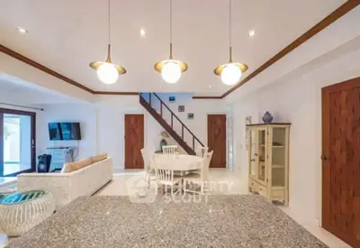 Spacious open-plan living room with modern decor and elegant lighting