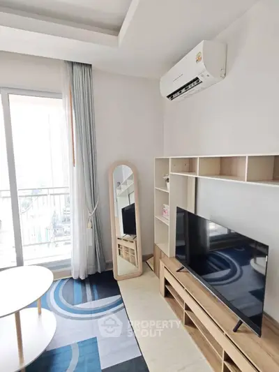 Modern living room with air conditioning and balcony view, featuring stylish furniture and decor.