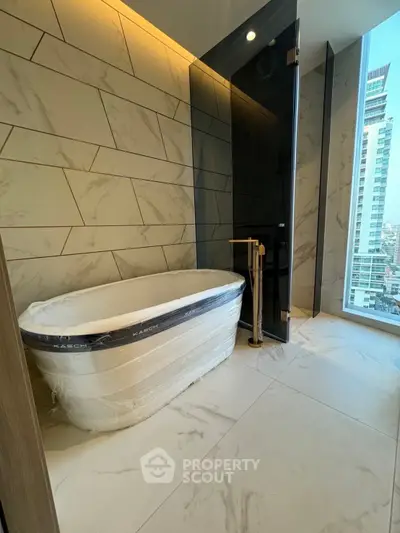Luxurious bathroom with modern bathtub and city view