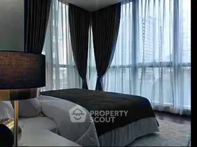 Luxurious bedroom with floor-to-ceiling windows and elegant curtains in a modern high-rise building.