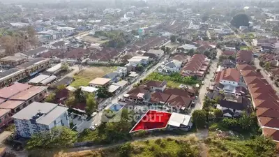 Aerial view of residential neighborhood with highlighted plot for sale, showcasing potential development opportunity.