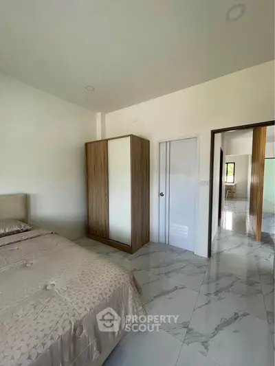 Spacious bedroom with modern wardrobe and elegant marble flooring
