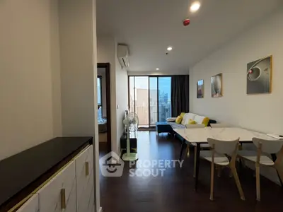 Modern living room with stylish decor and city view balcony