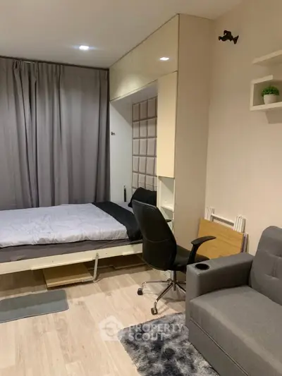 Modern studio apartment with foldable bed and cozy workspace