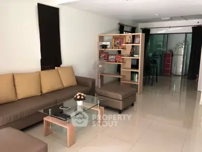 Spacious living room with modern furniture and open layout, perfect for relaxation and entertainment.