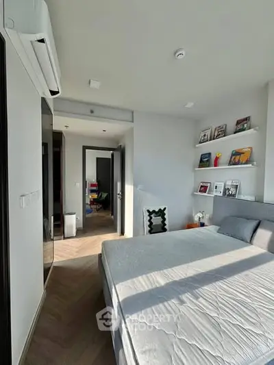 Modern bedroom with stylish decor and natural light in a contemporary apartment.