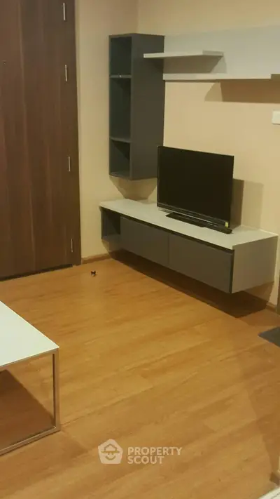 Modern living room with sleek TV unit and wooden flooring