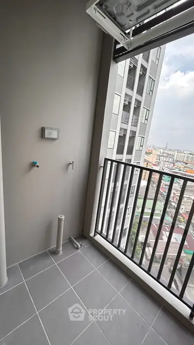 Modern apartment balcony with city view and laundry setup