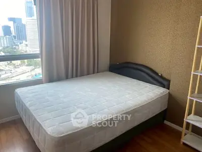 Cozy bedroom with city view, featuring a comfortable bed and elegant decor, perfect for urban living.