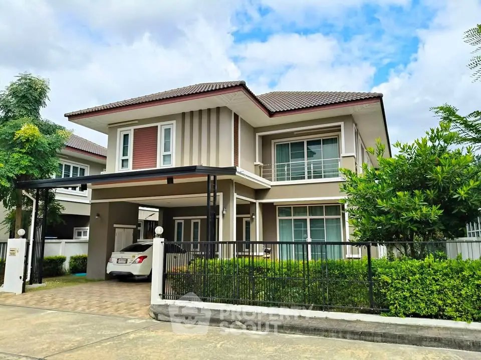 Stunning two-story house with modern design and lush greenery in a serene neighborhood.