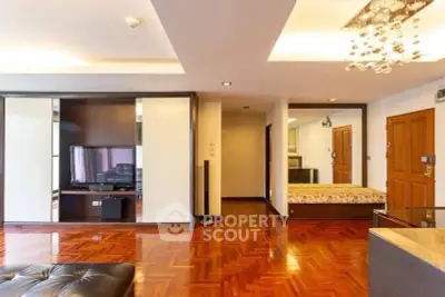 Spacious living room with elegant wooden flooring and modern lighting