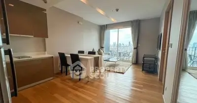 Spacious living room with dining area and balcony view in modern apartment
