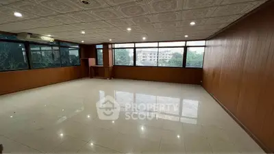 Spacious office space with large windows and tiled flooring, ideal for business setup.
