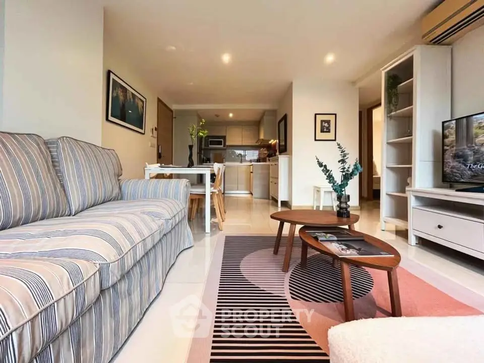 Spacious living room with modern decor and open kitchen layout