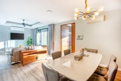 Spacious modern living and dining area with elegant lighting and natural light