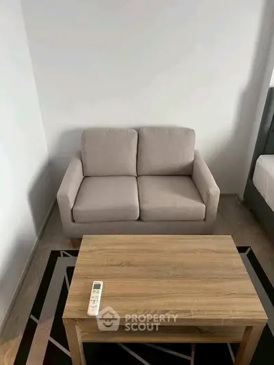 Cozy living room with modern sofa and wooden coffee table, perfect for relaxation.