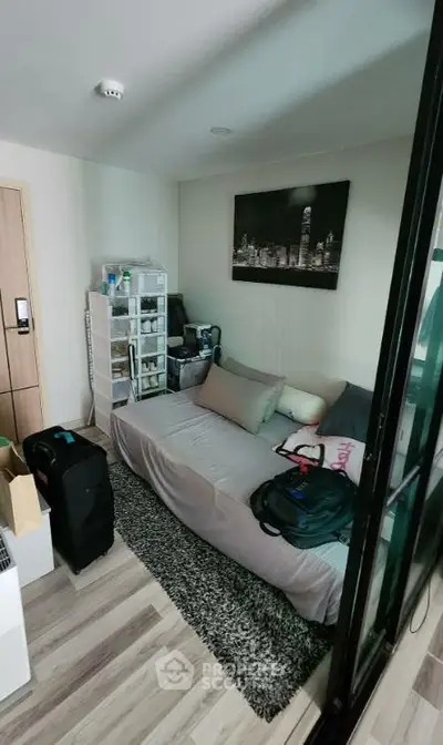 Cozy bedroom with modern decor and ample storage in a stylish apartment.