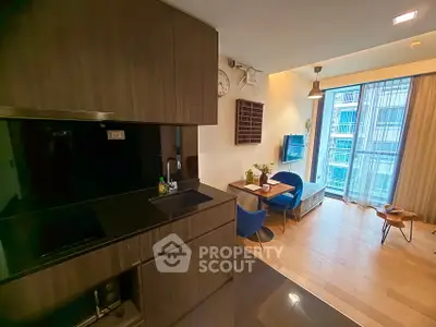 Modern open-layout kitchen and living room with sleek design and natural light.